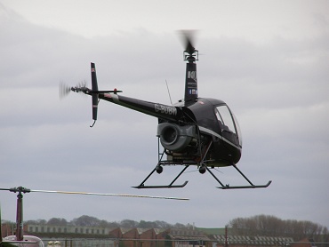 Robinson R22 Beta, G-BUBW, leaves the Museum Heliport